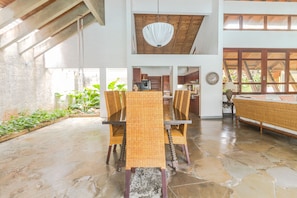 Dining table with 8 chairs and a lot of natural light.