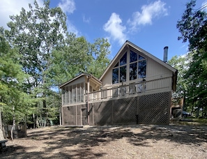 Full glass open living area with cathedral ceilings, lots of light and privacy