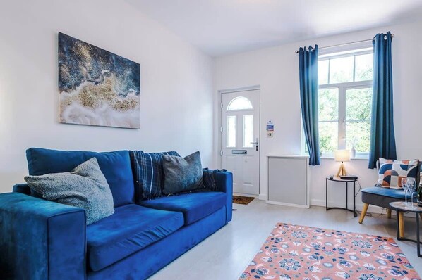 The living room benefits from a sofa bed and plenty of space to sit down and relax.
