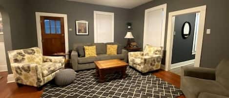 Spacious living room has ample seating to relax, watch TV, play games or visit.