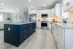 Chef's kitchen with induction range and full compliment of cookware and utensils