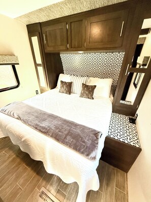 2nd bedroom includes a fire tv and clothes storage with hangers.