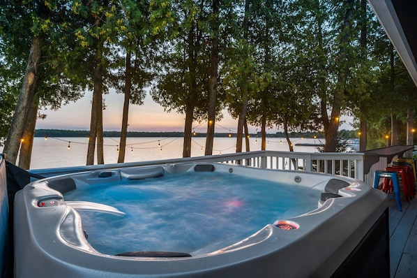 Unwind and relax in the 6 person hot tub overlooking the water.