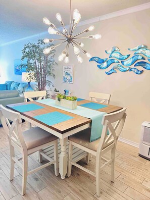 Gather together in this dining area, thoughtfully decorated with coastal colors.