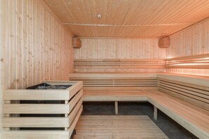 A sauna with wooden benches, offering a warm and relaxing retreat.