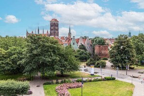 A picturesque view showcasing a beautiful park and nearby historic architecture.