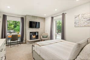 Beautiful guest bedroom with gas fireplace, closet, and desk