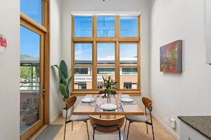 Beautiful dining nook flanked with floor-to-ceiling windows