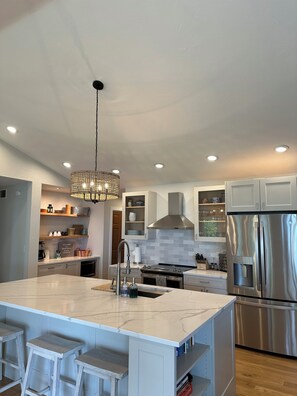 New kitchen with quartz countertops and counter-seating
