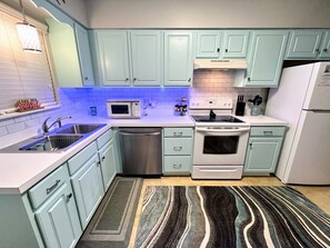 Well equipped kitchen with under-cabinet lighting.