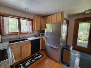 Electric flattop oven, large refrigerator and dishwasher.
