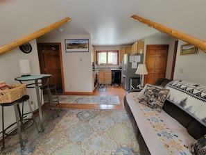 Deceptively spacious living room looking into the kitchen.