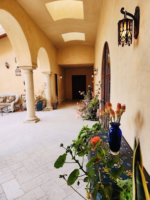 Beautiful Spanish-inspired hallway leading into the property.