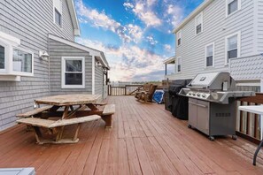 The communal deck space offers direct beach access for all guests. Please note that the BBQ grill on the patio belongs to the other unit. However, we do provide a Coleman BBQ grill that you are welcome to use. Feel free to take it outside to the pati
