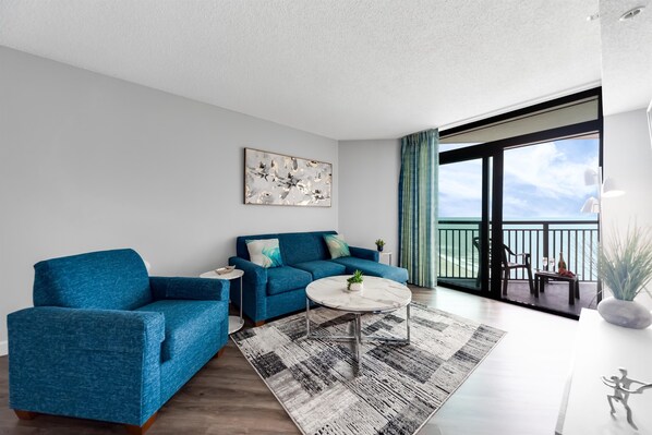 Coastal-inspired decor elements add a touch of seaside charm to the living area, enhancing the vacation experience.