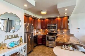 Inside dining table along with granite island for eating options for guests. 