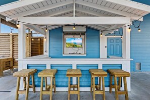 The tiki bar with the tv and string lights is a fun hangout on the ground floor.