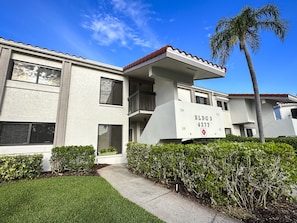 Lush, well-manicured foliage surrounds the unit and property.