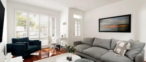 TV area with comfy sofa seats and study space