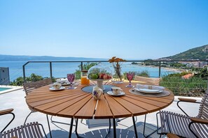 outdoor dining area with a sea view