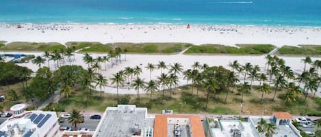 Aerial view over oceanfront CasaGrandeSouthBeach by AmericanVacationLiving on Ocean Drive in the heart of the Art Deco District with walking distance to Lincoln Road and South of Fifth's South Pointe Park. Walk, Jog or Bike around South Beach.
