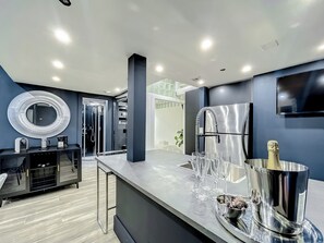 Full-size kitchen with brand new state-of-art Samsung stove, convection oven, air fryer, island bar with in-kitchen dining, entertaining 70-inch smart TV in the dining room, 50-inch in kitchen, stone dining table for up to 12 persons & bar seating.