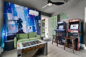 Game room with arcades, foosball, TV & tic-tac-toe—endless fun & relaxation!