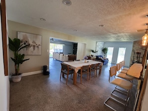 Dining room with 8 seats and 4 high top chairs. 