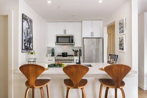 Bar area by the kitchen, with comfortable chairs. 