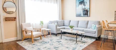 Enjoy Florida living at its finest in this coastal-inspired living room. We have included seating for the whole group, room darkening curtains, and even a cute spot to hang your keys, purse, or coat right by the front door!