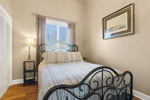 Sugar Berry's inviting bedroom with a ROKU TV, dresser, and washer/dryer unit.