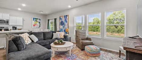 Living room with tall ceilings, lots of light and open concept!