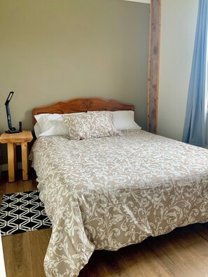 Second bedroom, custom side table and headboard, air conditioner.  