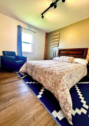 Master bedroom, leather chair, custom headboard, air conditioner