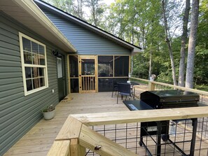 Open deck with steps to fire pit and creek 