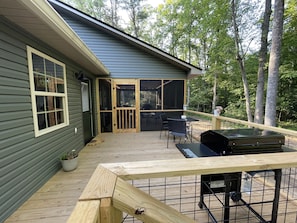 Open deck with steps to fire pit and creek 