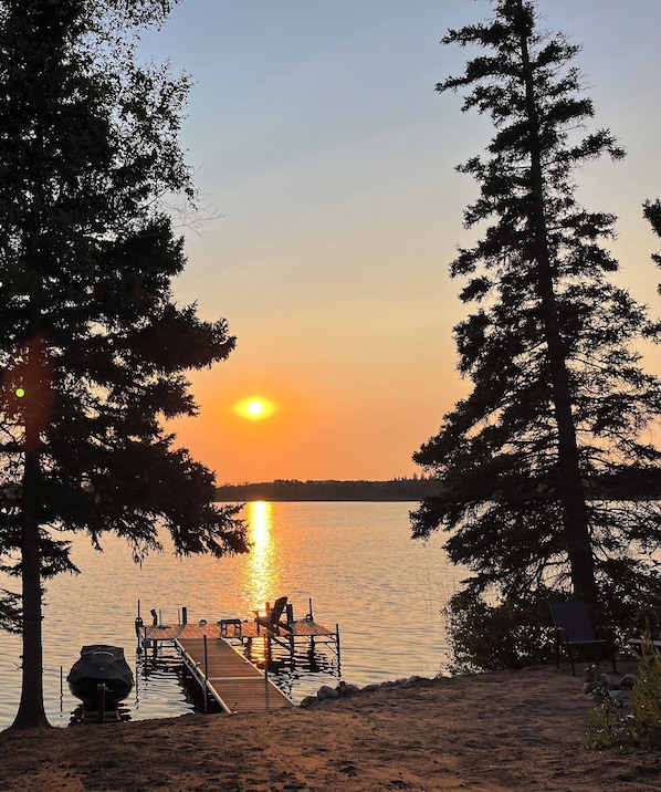 Watch the beautiful sunset from the private sand beach and dock.