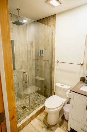 A beautiful walk-in shower featuring elegant tiles, a sleek glass enclosure, offering a luxurious and tranquil bathing experience.