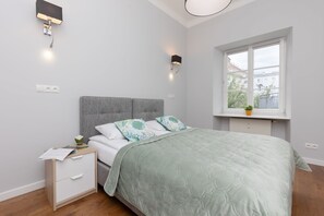 Another bedroom with a similar layout, featuring twin beds, bedding, and soft lighting, perfect for guests or family members.