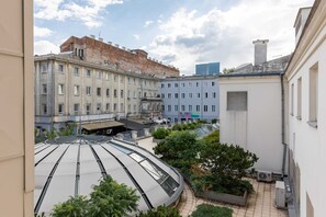 A charming outdoor space with a view of historic buildings and urban greenery.