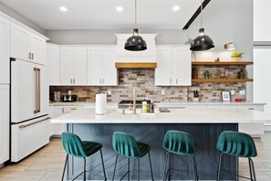 Kitchen with island and barstools, coffee provided