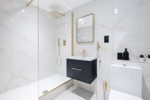 Luxurious bathroom with soaps, towels & built-in bidet for hygiene and comfort.