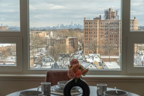 Dine in style with skyline views, high ceilings, and velvet rose seating.
