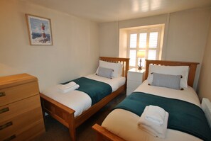 The twin bedroom is fresh and light