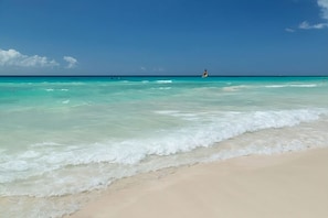 Beach nearby, white sand, sun loungers