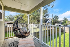 Relax in your balcony hammock chair overlooking your fenced in backyard space.
