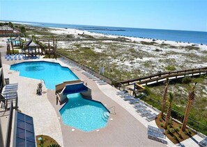 Pool, board walk to beach and jetty pass in the background.