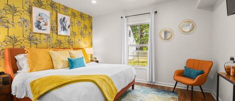 This brightly styled Master bedroom is just across the hall from the bathroom.