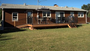 Large deck with table, chairs, umbrella and grill for you to enjoy the outdoors.