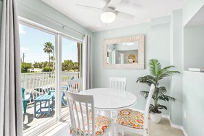This charming dining space is bathed in natural light, making every bite feel like a seaside escape.